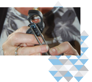 Tracey Kahle appraising a jewel for an insurance policy